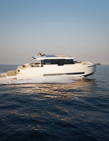 De Antonio D60 running underway showing slab-sided profile and enclosed glass saloon