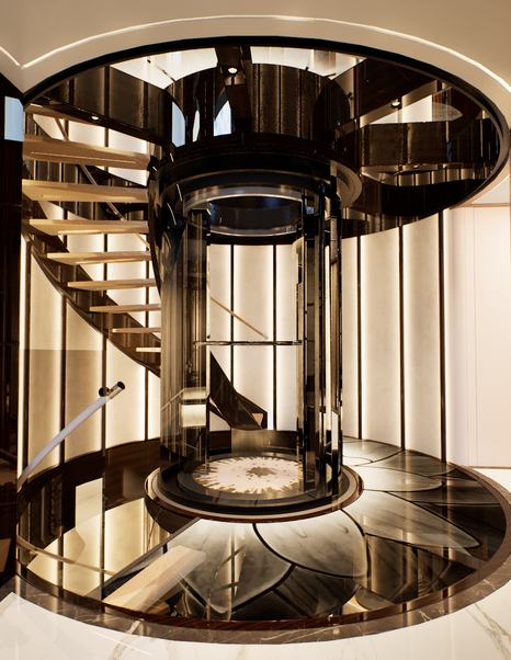 Superyacht Serenity II interior spiral staircase with glass central elevator
