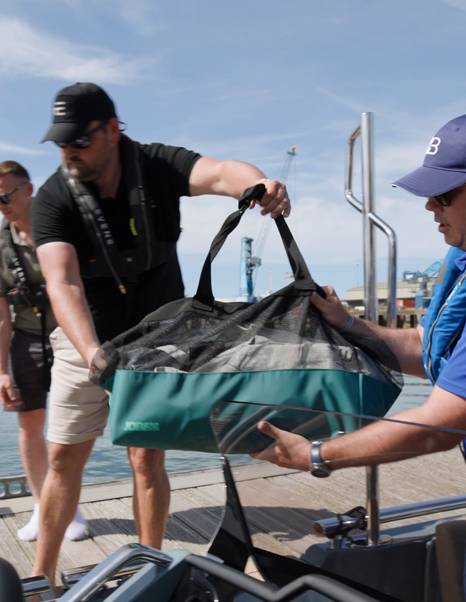 Luggage being loaded aboard the Evene Origin 71 during guest pickup