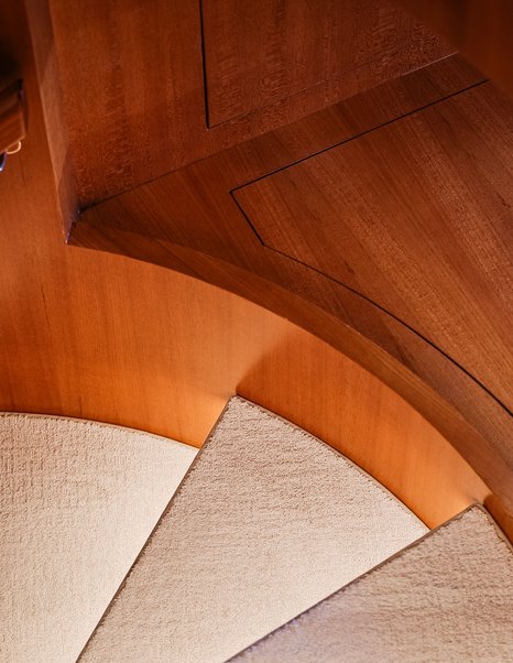 Fleming 85 curved companionway staircase with handcrafted teak joinery detail