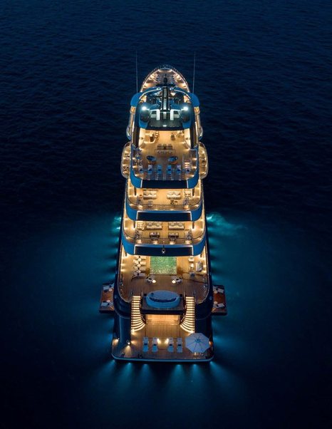 Aerial view of superyacht Here Comes The Sun illuminated at night