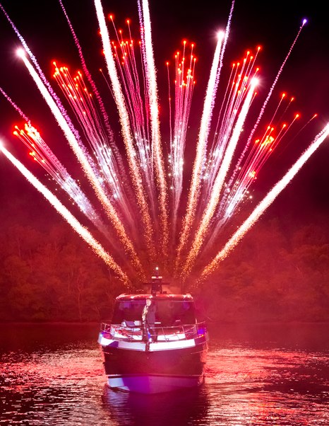 Riviera 5600 Sport Platinum Edition bow view during launch celebration with fireworks