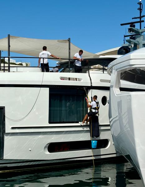 Workers cleaning yacht at 2025 cannes yachting festival