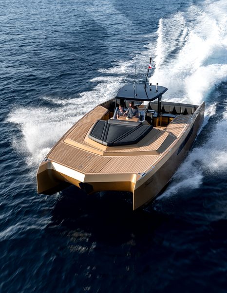 Sunreef Yachts 40 Open Power tender on water traveling at speed, with spray breaking and two people at helm