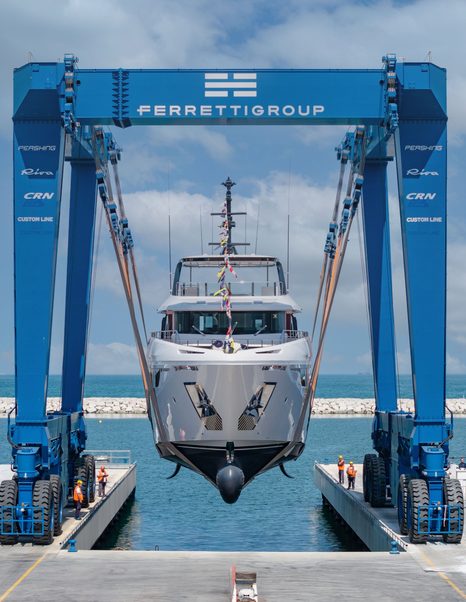 Bow shot of Custom Line Navetta 35 motor yacht being lowered into water at launch