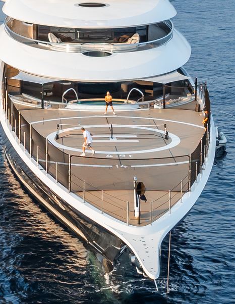People playing paddleboard on bow of superyacht Kismet
