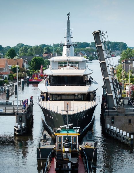 Bow shot of Feadship Superyacht Thalassa (Project 826) following tugboat through bridge in Dutch canals 
