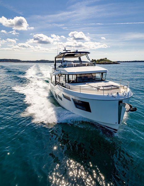 Beneteau Grand Trawler 63 profile underway highlighting enclosed flybridge and full-displacement hull