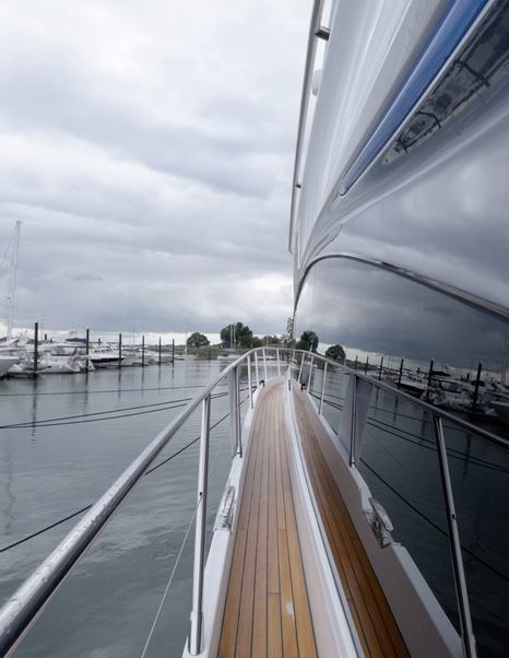 Princess S65 Mk2 teak side deck with guardrails and handholds along the superstructure