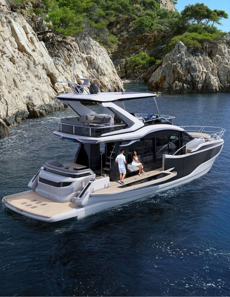 Galeon 520 Fly flybridge yacht at anchor with Beach Mode balconies deployed showing extended cockpit space and hydraulic bathing platform