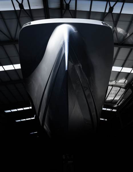 Bow shot of Superyacht Atlantide in shipyard in black and white 
