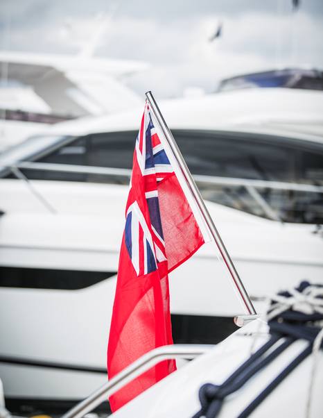 Close up of Union Jack flag in front of yacht