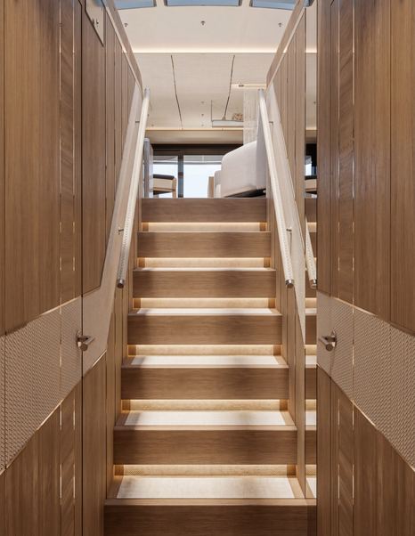 Rendering of Galeon 700 Sky Motor Yacht staircase with warm integrated LED lighting