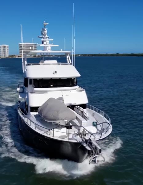 Nordhavn 75 EYF expedition yacht viewed from the bow underway with tender secured on the foredeck