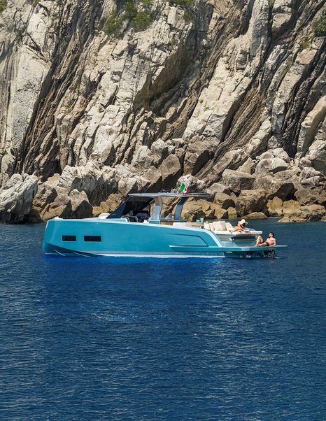 Pardo-43-Review-profile-view-at-anchor-off-rocky-coastline