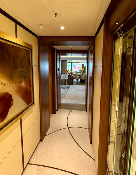 Interior corridor on the Amels 242 Casino Royale showing the polished wood panelling and guest access to the owner's saloon.