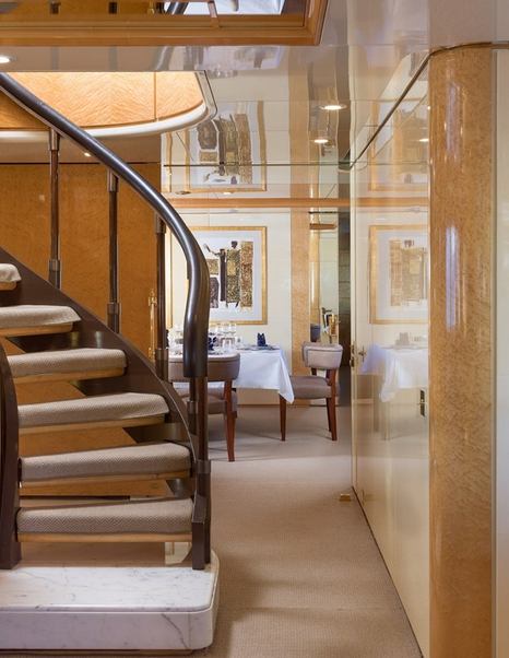 Feadship Superyacht Kassandra's interior staircase and dining area 