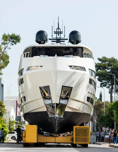 Front shot of First 31m Lazzara UHV 100 Superyacht bow on way to launch with trees behind 
