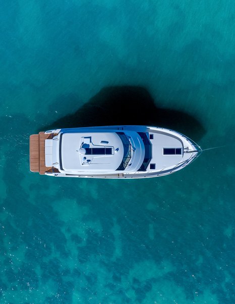 Aerial view of Maritimo M50 yacht at anchor showing full deck layout and foredeck sunpad area