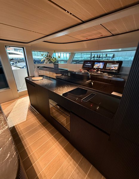 Bluegame-BGX83-Review-main-helm-with-open-plan-lounge-and-galley