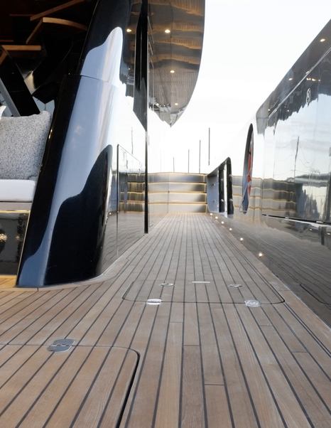 Sunreef Ultima 88 wide side deck with teak flooring and steps to the aft cockpit