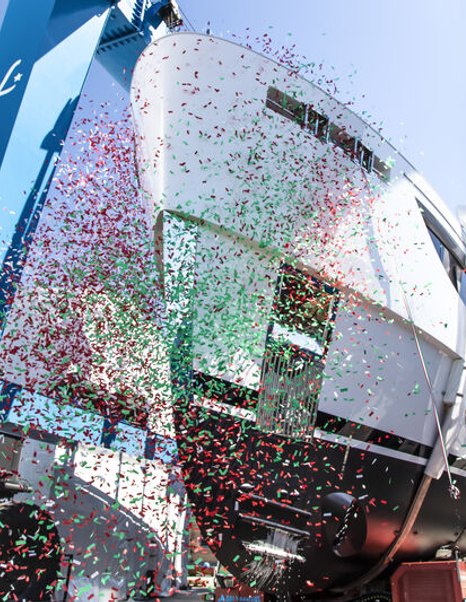 Upwards view of Benetti Oasis 34M hull during launch ceremony. Image of under bow decorated by falling confetti.