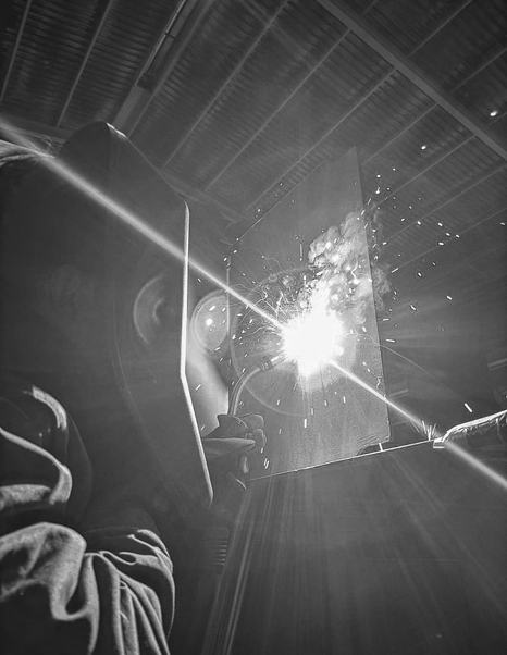 Man welding hull of ISA Gran Turismo 68M superyacht in black and white