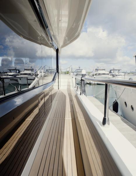 Beneteau Grand Trawler 63 starboard side deck with wide teak walkway and secure guardrails