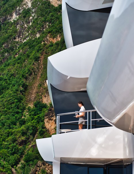 Lady standing in front of expansive glass window on Superyacht ARTEFACT