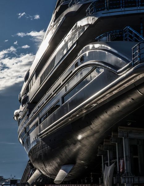 Steel exterior of LANA superyacht by Benetti, sun glinting off of body of the yacht