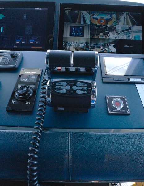 Benetti Oasis 34M helm controls with engine throttles, vessel management systems and integrated monitoring displays.