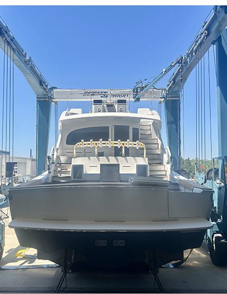 Stern shot of Viking 90C Sportsfisher Yacht leaving shipyard