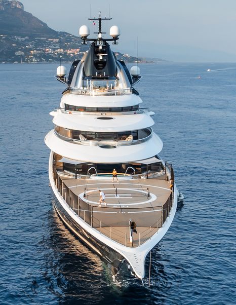 Bow shot of Superyacht Kismet with people playing paddle on foredeck 