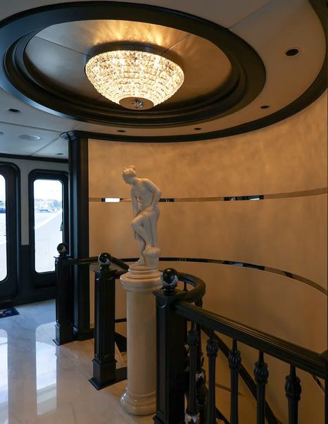 Trinity superyacht Mirabella interior spiral staircase with greek statue 