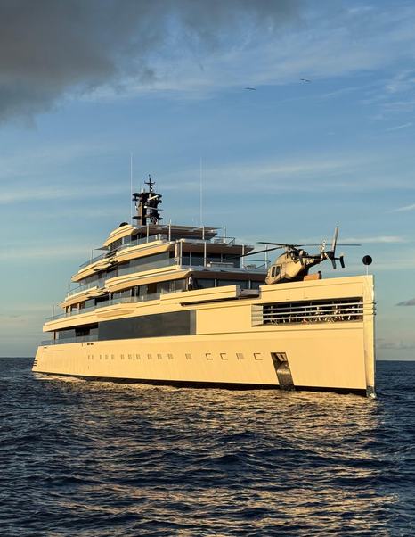 Superyacht Ulysses with helicopter on bow at anchor in St Barts for NYE