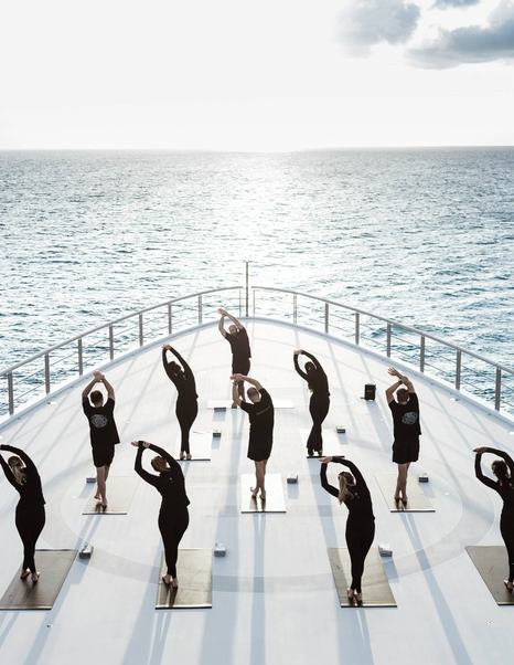 People doing yoga on foredeck of Oceanco superyacht Leviathan 