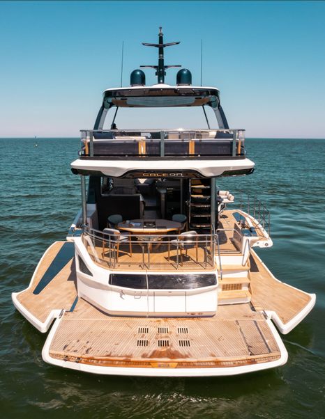 Stern view of the Galeon 620 Fly showing fold-down side terraces and hydraulic bathing platform.