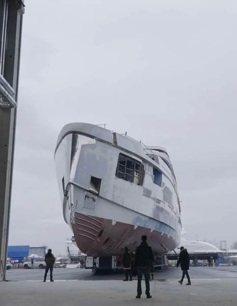 Flagship Amer 74 Steel superyacht entering shipyard with workers below