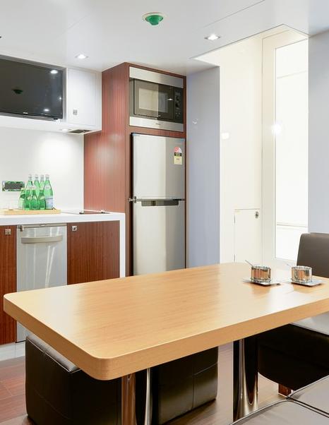 Galley on yacht, showing refrigerator with microwave above