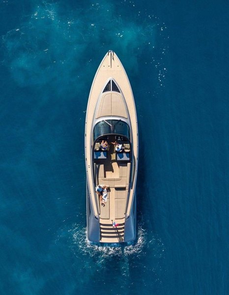 Large chase boat viewed from above on clear blue water