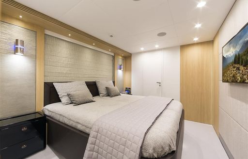 Cabin onboard the superyacht O NOSO UNO, central berth facing starboard, directly opposite a wall-mounted TV