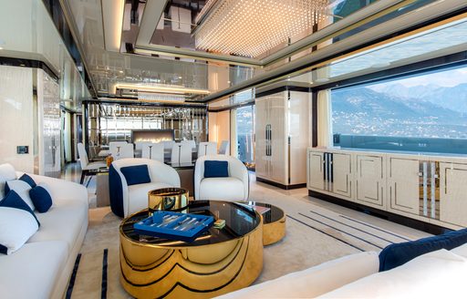 Light and airy salon on superyacht STEFANIA with seats and table visible