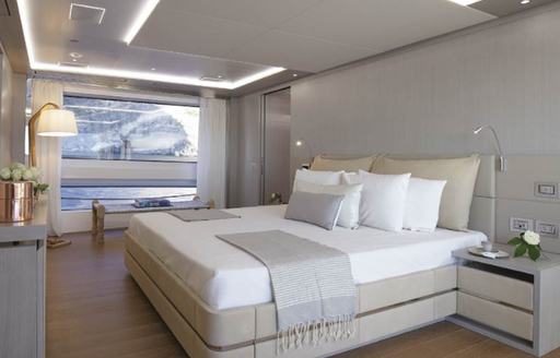 Overview of the master cabin onboard motor yacht LOUI, central berth and large window aft