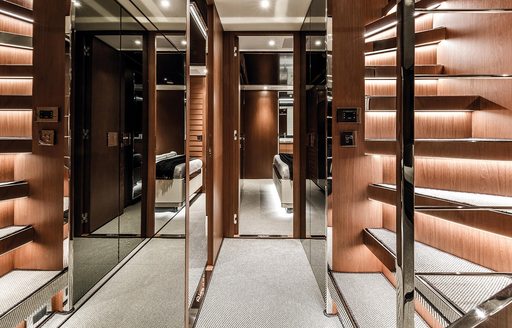 hallway with mirrored panels, white carpets and wooden steps on board Argo 90 yacht