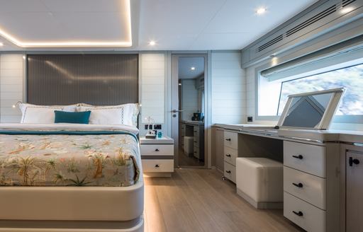 Master cabin onboard Sirena 78, central berth with dressing table to starboard.