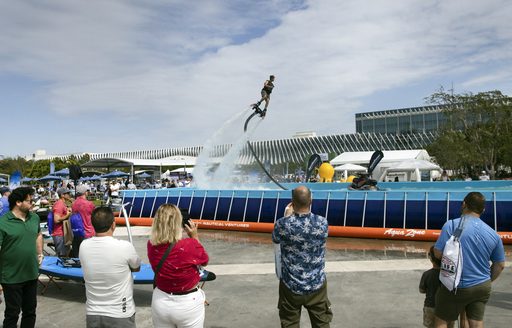 Flyboarding demonstration with spectators in the foreground