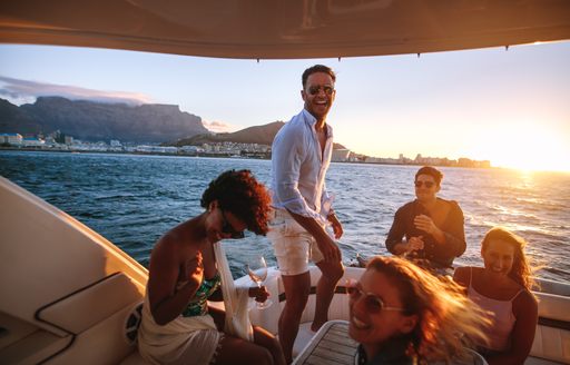 yacht owner and guests on aft deck sunset