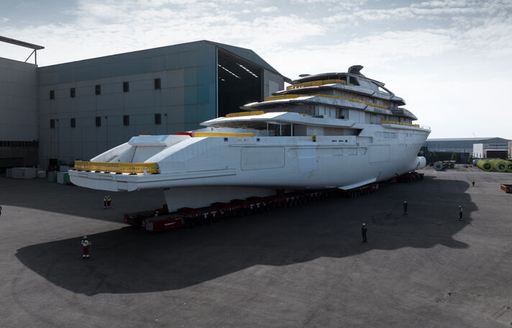 Aft view of Oceanco Project Y722 on tarmac outside construction shed