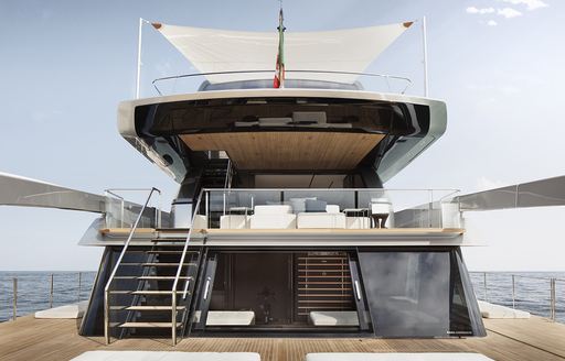 Stern onboard Sanlorenzo SX112 crossover yacht, overview of aft area of yacht with beach club environment and stairs to main deck exteriors