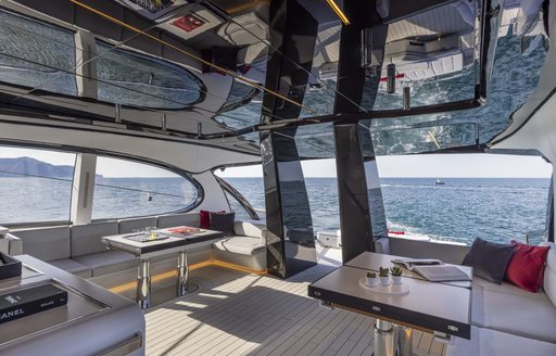 Interior of superyacht ALDABRA with seating and tables visible